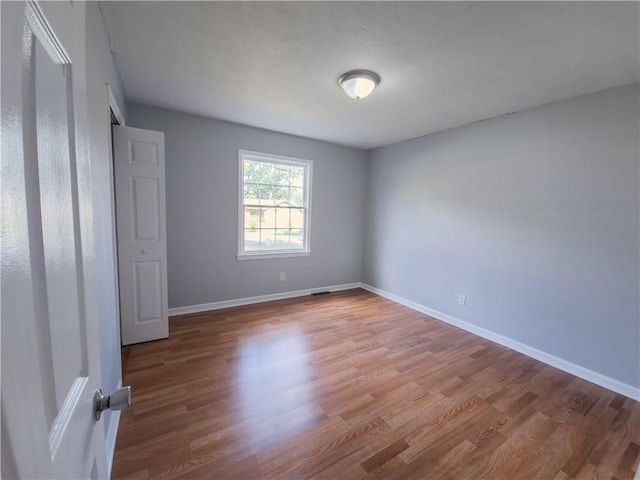 unfurnished bedroom with hardwood / wood-style flooring