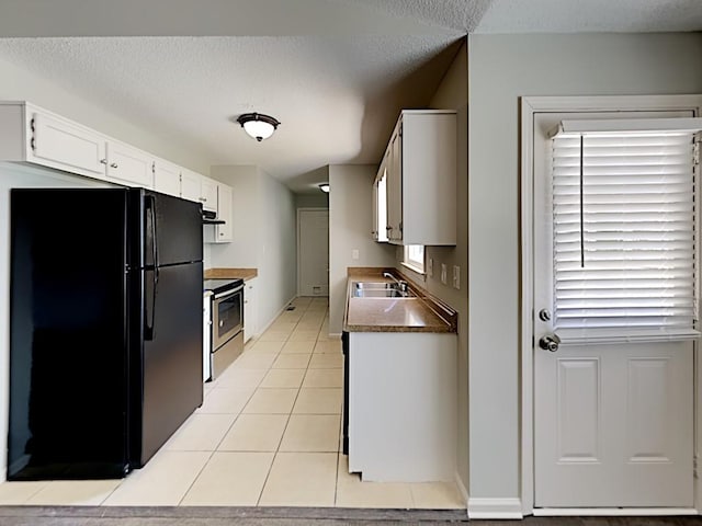 365 Wesley Mill Pl, Villa Rica, GA 30180 - kitchen featuring freestanding refrigerator, electric range, white cabinetry, light tile patterned floors, and extractor fan