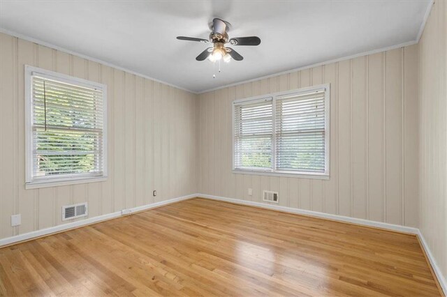 unfurnished room featuring crown molding, ceiling fan, and light wood-type flooring