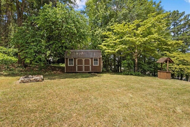 view of yard featuring a fire pit and a shed