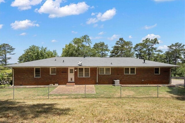 rear view of house with a yard and a patio