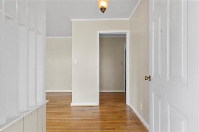 interior space with ornamental molding and light wood-type flooring