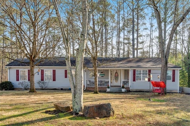 ranch-style home featuring a porch and a front yard