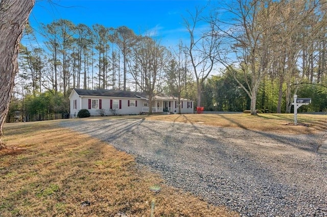 ranch-style home with a front lawn