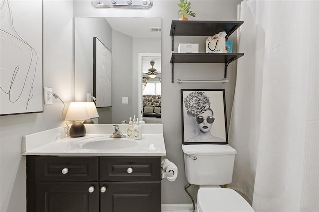 bathroom featuring visible vents, toilet, and vanity