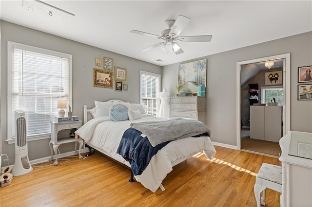 bedroom featuring light wood-style flooring, ceiling fan, and baseboards