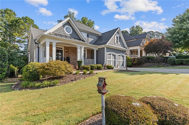 view of front of home with a front yard and covered porch