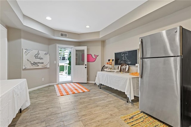interior space featuring wood finished floors, baseboards, visible vents, and recessed lighting
