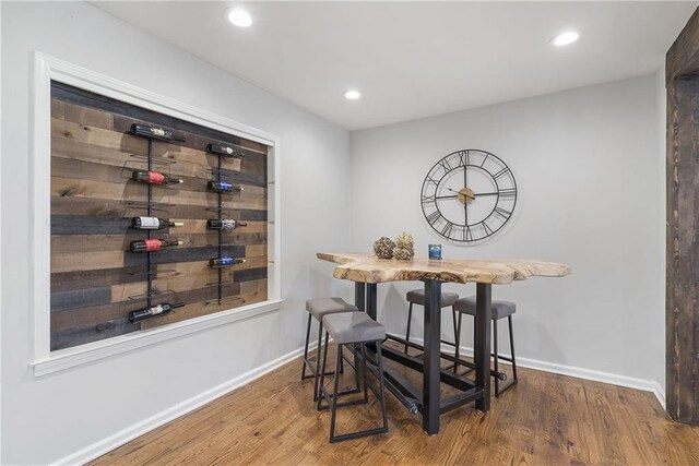 dining space with wood finished floors, baseboards, and recessed lighting