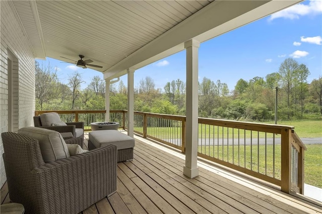wooden terrace featuring a ceiling fan