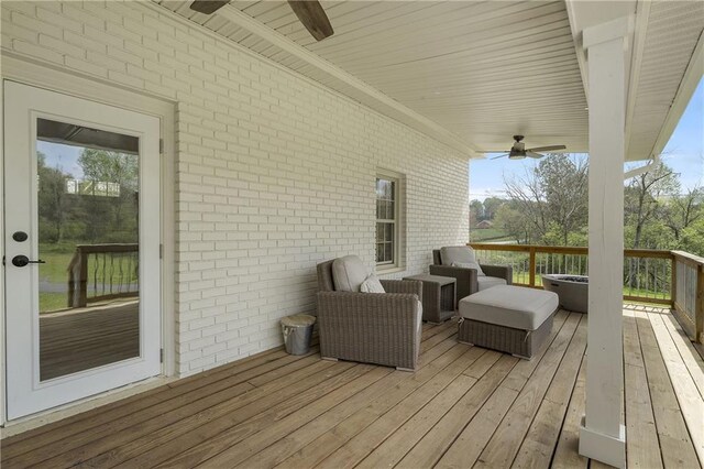 wooden deck featuring a ceiling fan