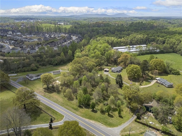 drone / aerial view with a forest view and a mountain view