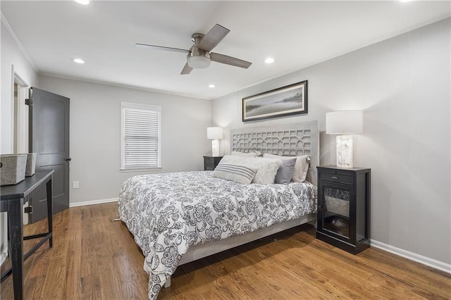 bedroom featuring ceiling fan, ornamental molding, recessed lighting, wood finished floors, and baseboards