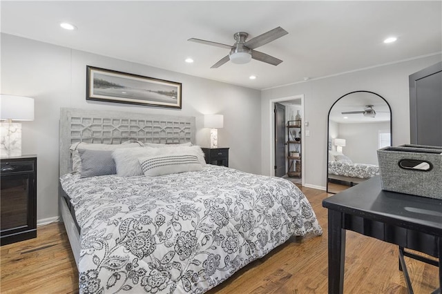 bedroom featuring baseboards, recessed lighting, and wood finished floors