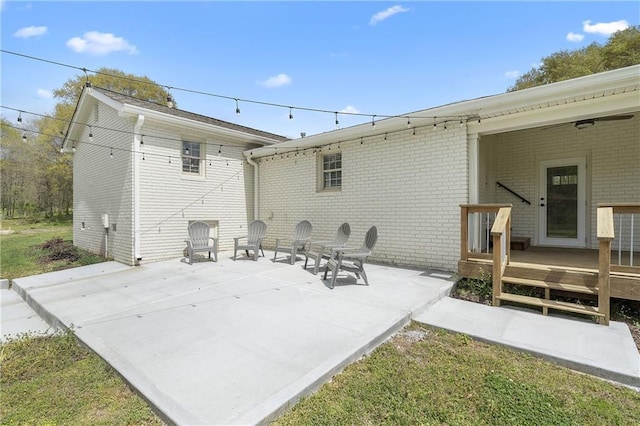 rear view of house with a patio area and brick siding