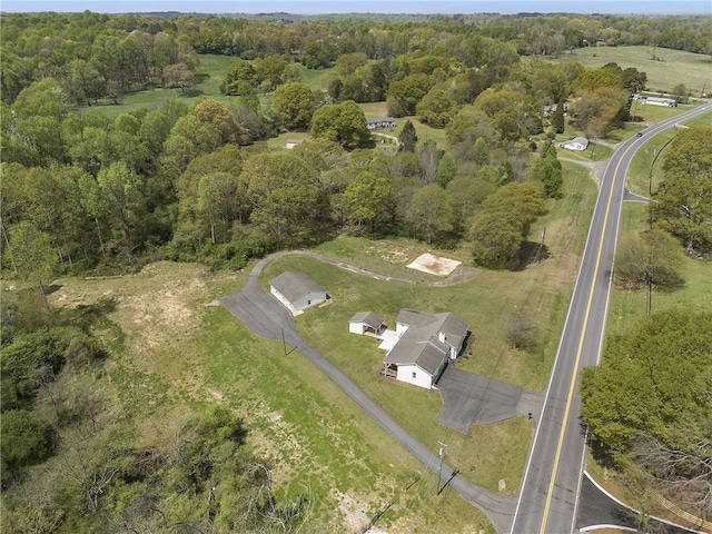 drone / aerial view featuring a wooded view and a rural view