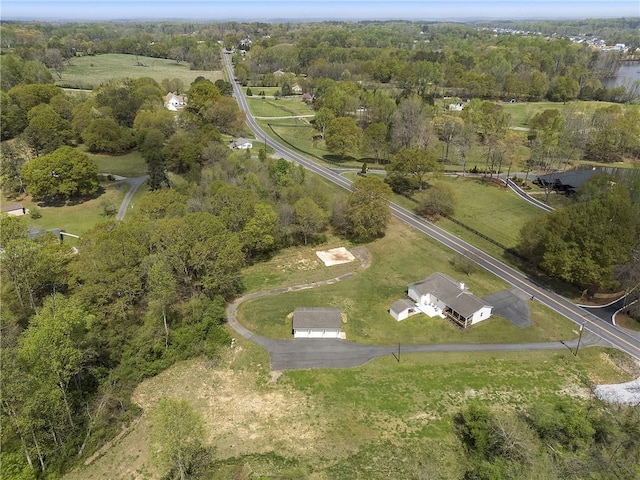 aerial view featuring a view of trees and a rural view