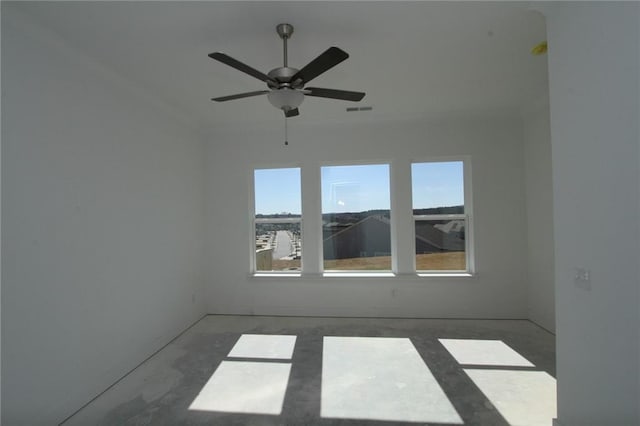 unfurnished room with ceiling fan and visible vents