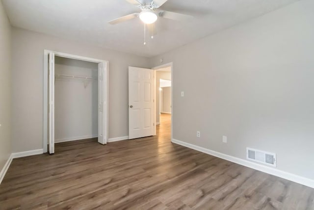 210 Riveredge Way, Mcdonough, GA 30252 - unfurnished bedroom featuring wood finished floors, baseboards, a closet, and ceiling fan