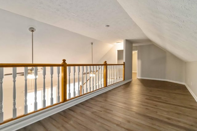 210 Riveredge Way, Mcdonough, GA 30252 - bonus room featuring a textured ceiling, wood finished floors, vaulted ceiling, and baseboards
