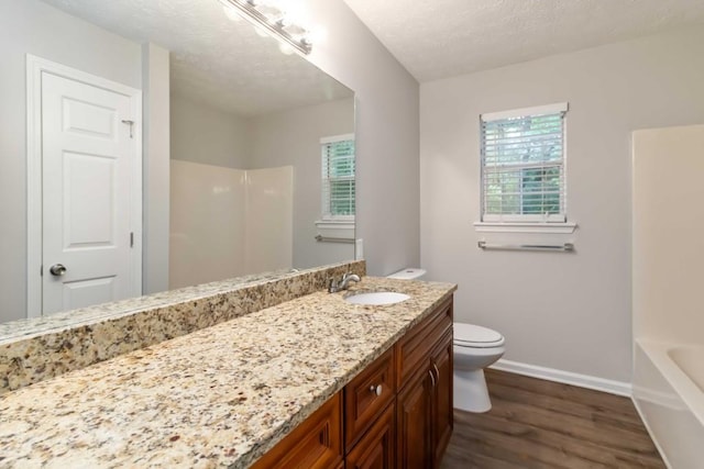 210 Riveredge Way, Mcdonough, GA 30252 - full bath featuring vanity, wood finished floors, toilet, baseboards, and a textured ceiling