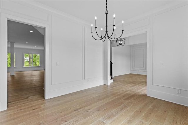 6120 Hutchins Dr, Buford, GA 30518 - unfurnished dining area with a chandelier, light wood-type flooring, a decorative wall, and recessed lighting