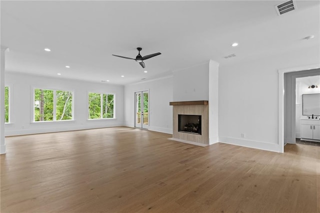 6120 Hutchins Dr, Buford, GA 30518 - unfurnished living room featuring light wood finished floors, recessed lighting, baseboards, a ceiling fan, and a fireplace with flush hearth