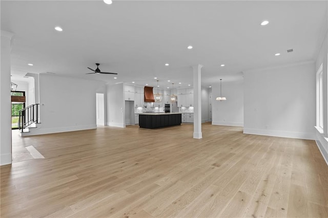6120 Hutchins Dr, Buford, GA 30518 - unfurnished living room featuring recessed lighting, baseboards, a chandelier, ceiling fan, and light wood-style floors