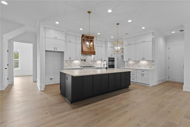 6120 Hutchins Dr, Buford, GA 30518 - kitchen featuring a sink, white cabinets, light countertops, tasteful backsplash, and recessed lighting