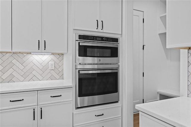 6120 Hutchins Dr, Buford, GA 30518 - kitchen featuring double oven, white cabinetry, and light countertops
