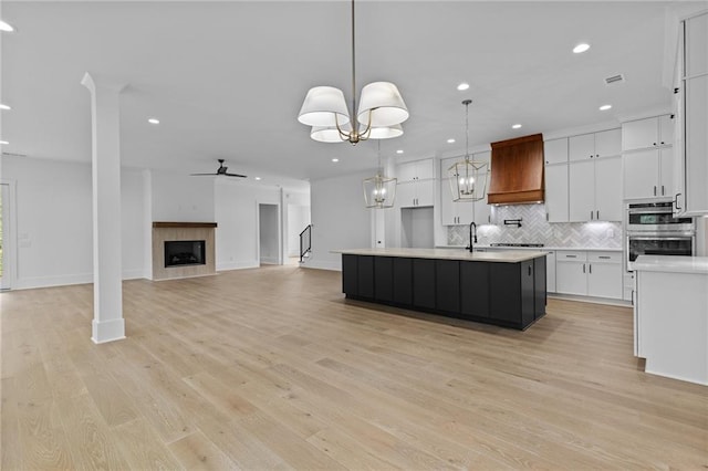 6120 Hutchins Dr, Buford, GA 30518 - kitchen with stainless steel double oven, recessed lighting, decorative backsplash, light countertops, and white cabinets
