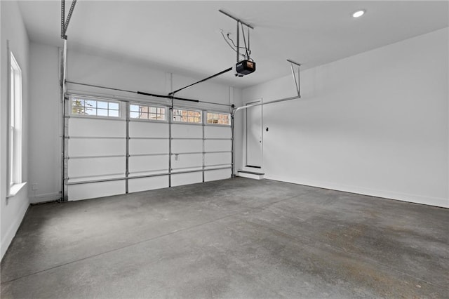 6120 Hutchins Dr, Buford, GA 30518 - garage featuring a garage door opener and baseboards