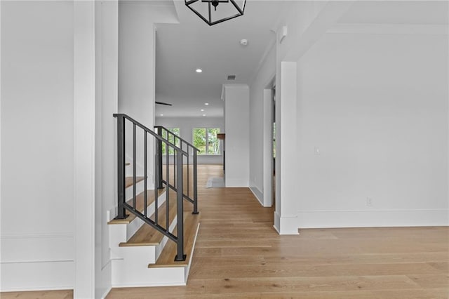 6120 Hutchins Dr, Buford, GA 30518 - hall with wood finished floors, stairway, baseboards, and recessed lighting