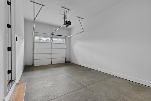 6120 Hutchins Dr, Buford, GA 30518 - garage with a garage door opener and baseboards