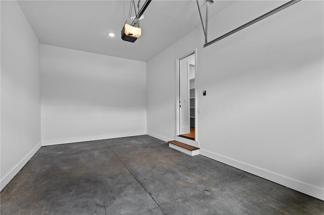 6120 Hutchins Dr, Buford, GA 30518 - garage featuring a garage door opener and baseboards