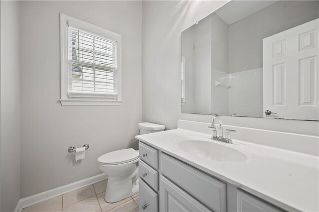 6329 Edgewater Cv, Fairburn, GA 30213 - bathroom with vanity, baseboards, tile patterned flooring, toilet, and tiled shower