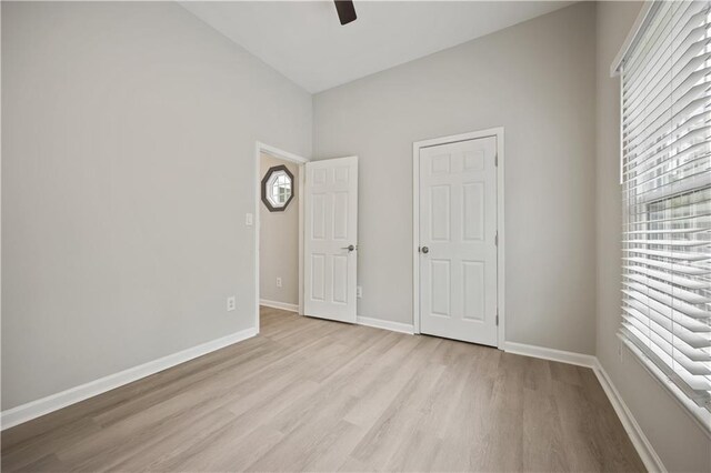 6329 Edgewater Cv, Fairburn, GA 30213 - unfurnished bedroom with baseboards, light wood finished floors, vaulted ceiling, and a ceiling fan