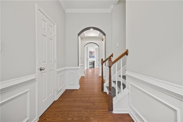 6329 Edgewater Cv, Fairburn, GA 30213 - hall featuring crown molding, arched walkways, wainscoting, and dark wood finished floors