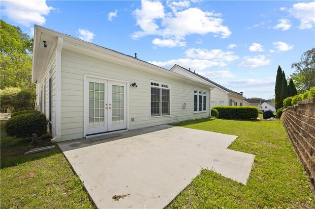 6329 Edgewater Cv, Fairburn, GA 30213 - back of property featuring a patio, french doors, fence, and a lawn