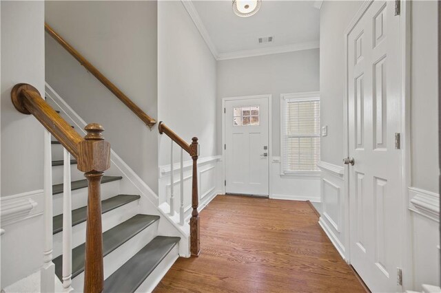 6329 Edgewater Cv, Fairburn, GA 30213 - foyer with wood finished floors, a decorative wall, ornamental molding, and stairs