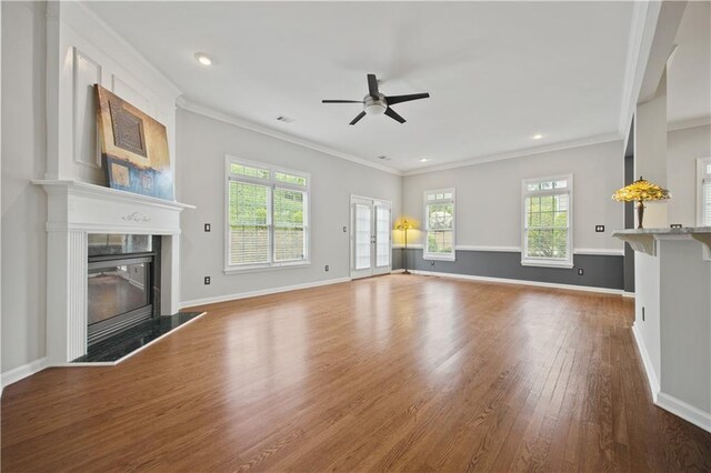 6329 Edgewater Cv, Fairburn, GA 30213 - unfurnished living room featuring ornamental molding, wood finished floors, ceiling fan, and a glass covered fireplace