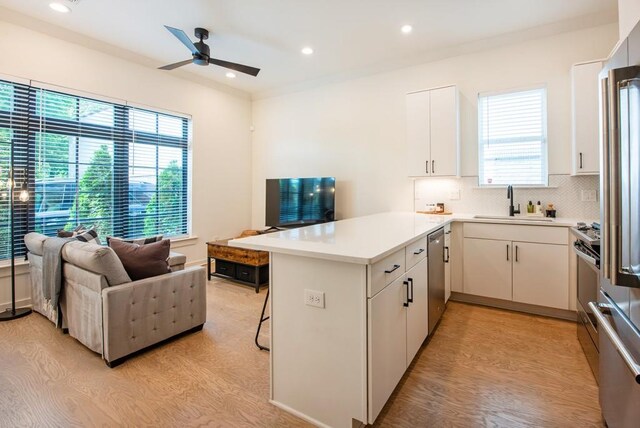 417 E College Ave Unit 102, Decatur, GA 30030 - kitchen featuring a peninsula, a sink, open floor plan, tasteful backsplash, and dishwasher
