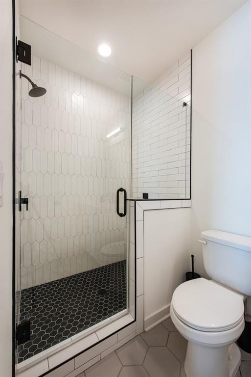 417 E College Ave Unit 102, Decatur, GA 30030 - bathroom with tile patterned floors, a shower stall, toilet, and recessed lighting