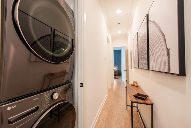 417 E College Ave Unit 102, Decatur, GA 30030 - laundry room featuring stacked washing machine and dryer, wood finished floors, baseboards, and recessed lighting