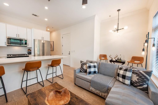 417 E College Ave Unit 102, Decatur, GA 30030 - living room featuring a chandelier, light wood-style floors, healthy amount of natural light, and recessed lighting