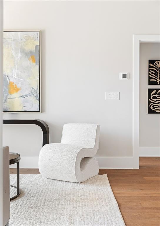 living area featuring wood finished floors and baseboards