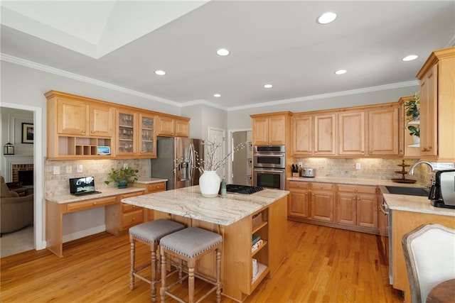 kitchen featuring open shelves, appliances with stainless steel finishes, light wood-type flooring, and a center island