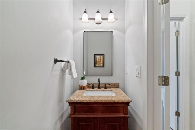 bathroom featuring baseboards and vanity