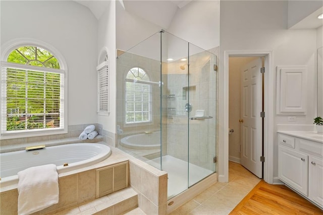 full bath with vanity, tile patterned floors, a garden tub, and a stall shower