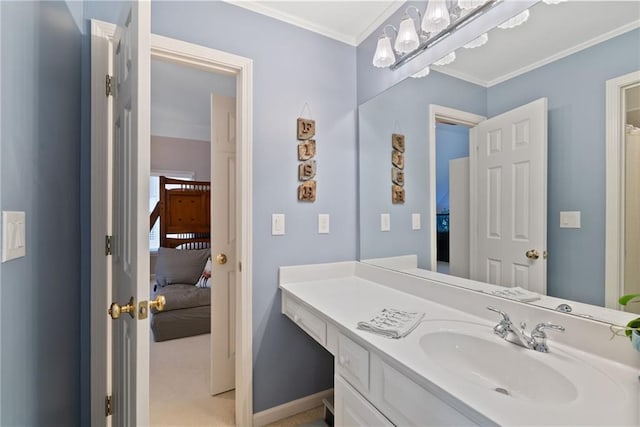 ensuite bathroom featuring vanity, ornamental molding, baseboards, and ensuite bath
